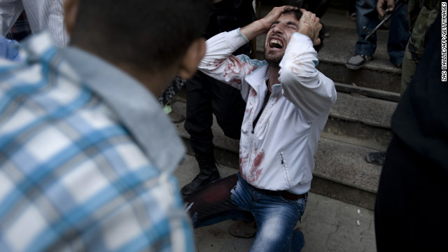 A Syrian man mourns the death of his father, who was killed during a government attack in Aleppo on October 10, 2012.