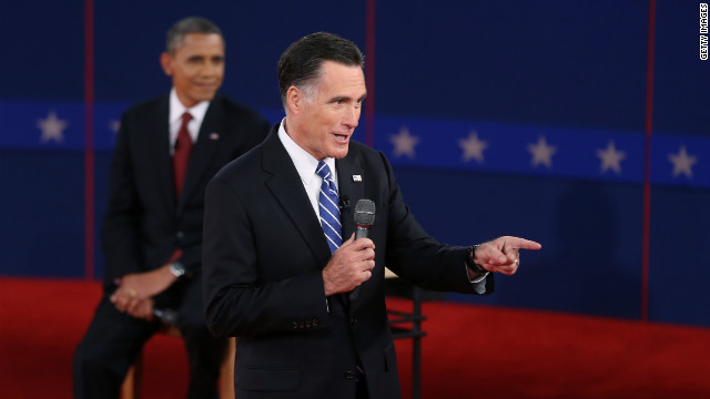 Republican presidential candidate Mitt Romney addresses a question as President Obama listens.