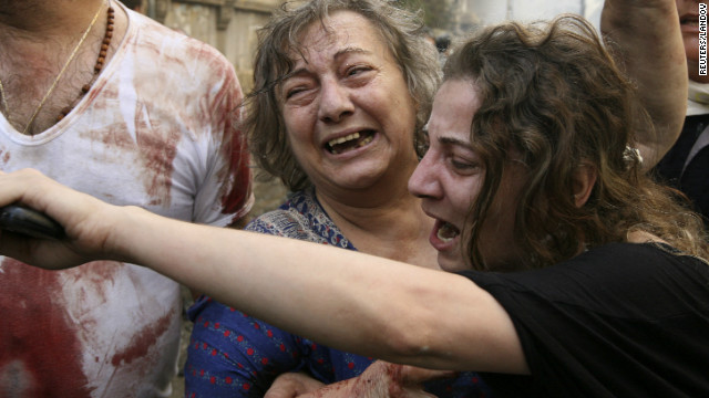 Relatives comfort a wounded woman at the site.