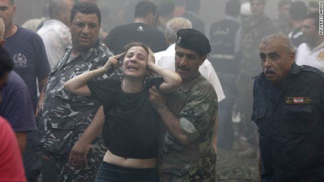 A woman is helped by a Lebanese soldier after the explosion.