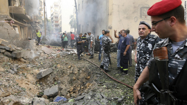 Lebanese police stand by a crater as they secure the site.