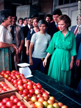 Arkansas Gov. Bill Clinton helps first lady Rosalynn Carter on a campaign swing through Arkansas in June 1979. Also seen is Hillary Clinton (center background).