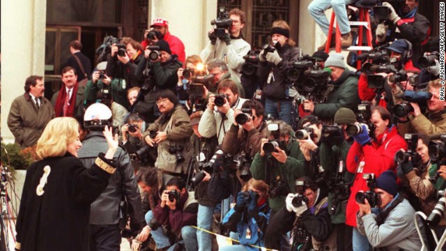 Clinton, left, waves to the media on January 26, 1996, as she arrives at federal court in Washington for an appearance before a grand jury. The first lady was subpoenaed to testify as a witness in the investigation of the Whitewater land deal in Arkansas.