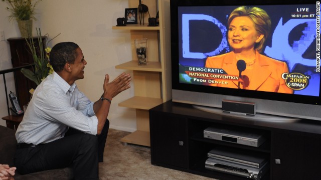 U.S. Democratic presidential candidate Barack Obama watches Sen. Hillary Clinton address the Democrate National Convention at a Democratic supporters' group in Billings, Montana, on August 26, 2008. The two endured a long, heated contest for the 2008 nomination.