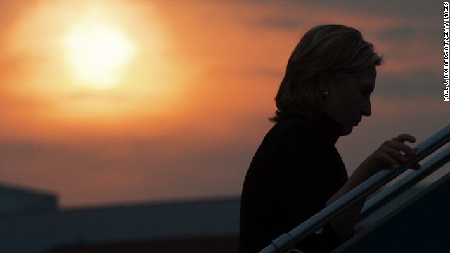 Clinton walks up the steps to her aircraft at sunset as she leaves an ASEAN meeting July 23, 2010, in Hanoi, Vietnam.