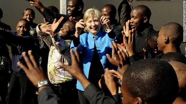 Clinton dances with a local choir as while visiting the Victoria Mxenge Housing Project in Philippi on the outskirts of Cape Town, Souith Africa, on August 8, 2009.