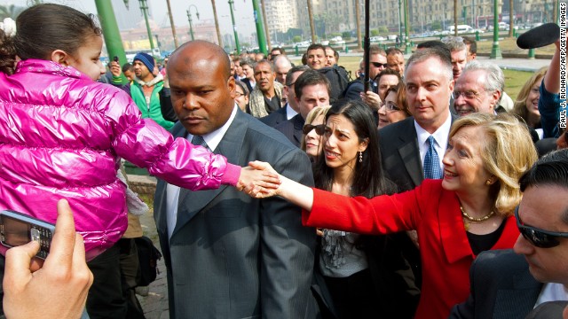 Clinton shakes hands with a child during an unannounced walk through Tahrir Square in Cairo, Egypt, on March 16, 2011.