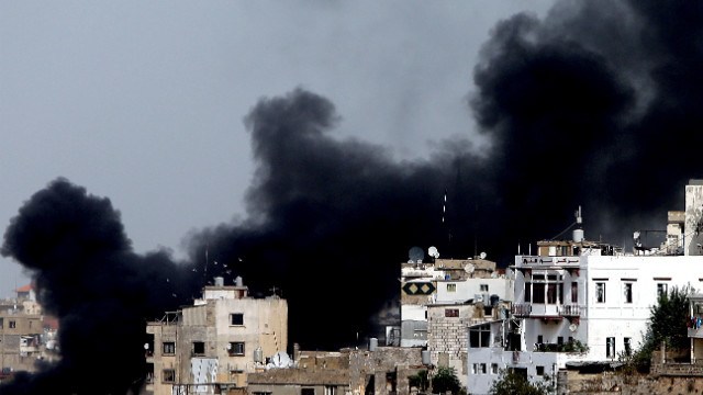 Smoke billows in Tripoli's Bab al-Tabanneh neighborhood during clashes between Alawites, an offshoot of Shiite Islam, and anti-government supporters on Monday, October 22. Fighting continued in Tripoli and Beirut, where a top police official was killed in a car bombing. At least two people were killed in Tripoli and several wounded in Beirut.