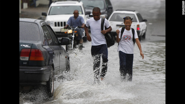 Students walk in floodwater from Hurricane Sandy's rain in Santo Domingo, Dominican Republic, on Wednesday.