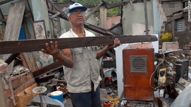 A man clears debris from his house on Thursday. It was demolished by Hurricane Sandy in Santiago de Cuba.