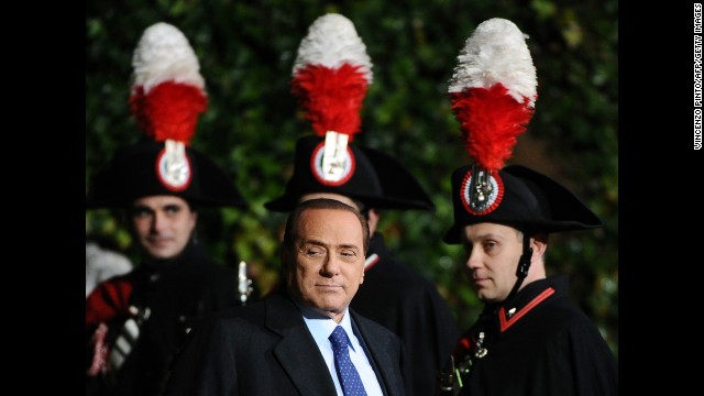 Berlusconi passes by Carabinieri guards prior a meeting with Russia's President at Villa Madama palace in Rome on February 16, 2011.