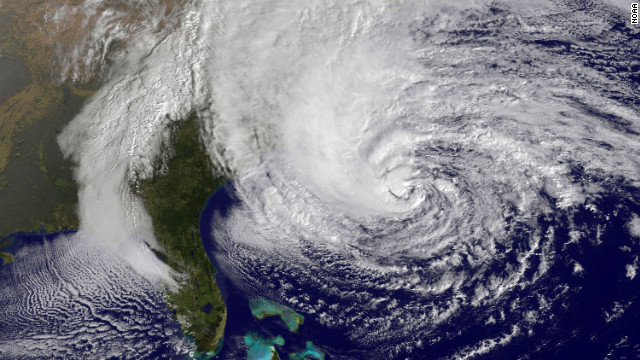 A satellite image from 10:10 a.m. ET on Sunday shows Hurricane Sandy in the Atlantic Ocean grazing the East Coast. The storm is expected to cause massive flooding and widespread power outages when it hits the East Coast late Sunday and into the week. 