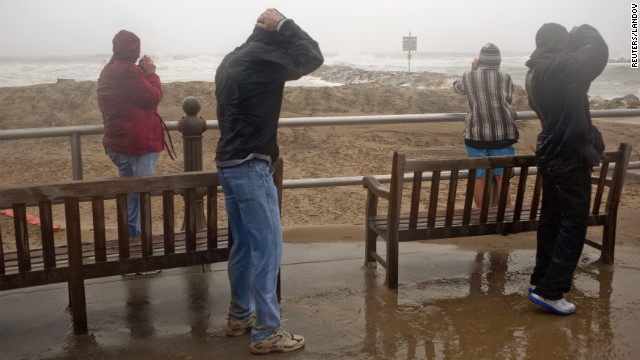 People look at the surf as high winds and heavy rain from Hurricane Sandy arrive in Virginia Beach, Virginia, on Sunday. 