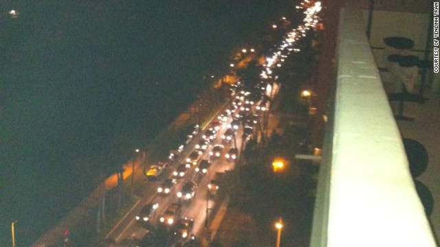 Cars are seen on Ala Wai Blvd. in Honolulu's Waikiki in Hawaii on Saturday before the arrival of the first tsunami waves.