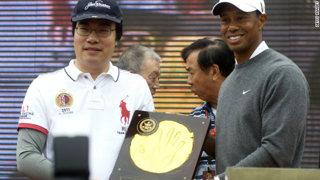 Both McIlroy and Woods, pictured above, had their handprints immortalized in clay as a lavish ceremony featuring drum majorettes and fireworks preceded their clash in the Chinese city Zhengzhou. 
