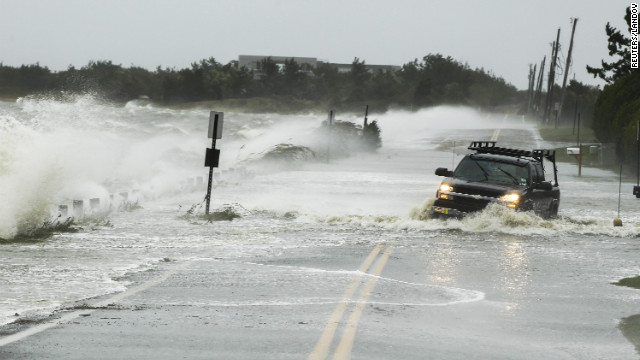 A truck fights its way through water on a road in Southampton, New York, on Monday.