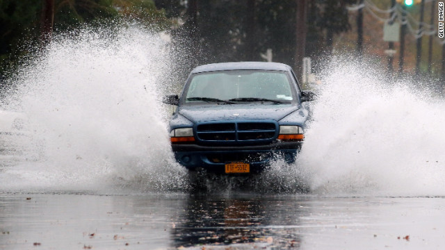 A truck moves north on South Long Beach Avenue as rising water and wind ahead of Hurricane Sandy flood the area on Monday in Freeport, New York. The storm, which threatens 50 million people in the eastern third of the United States, is expected to bring days of rain, high wind and, in places, heavy snow.
