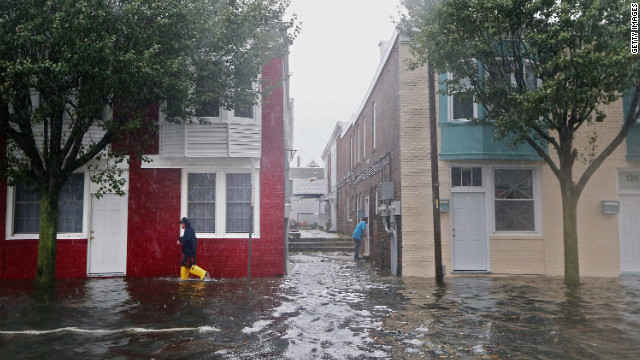 A man walks down a flooded street in Atlantic City on Monday before the hurricane makes landfall.