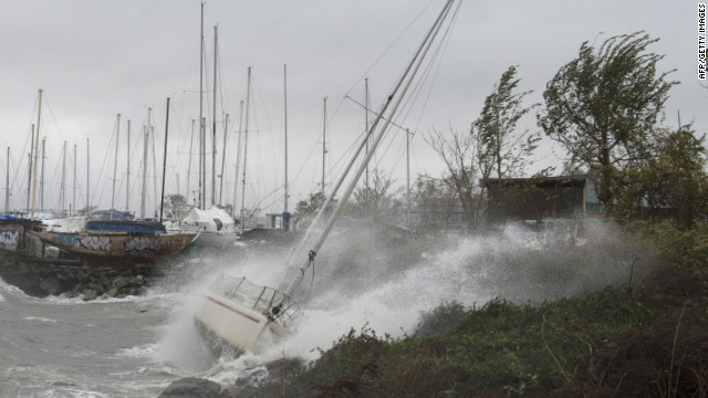 A sailboat smashes on the rocks after breaking free from its mooring on City Island, New York, on Monday.