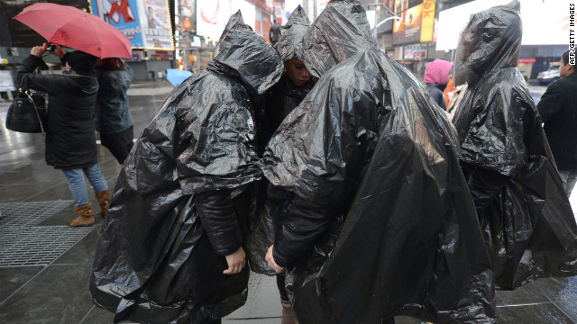 Tourists wear plastic ponchos in Times Square on Monday. 