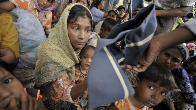 Khin Khin Thant, a mother-of-four displaced by the violence receives donated clothes in a camp in Sittwe, Myanmar. She and thousands like her are in need of life-saving asssistance, the U.N. says.<br/><br/><br/><br/>