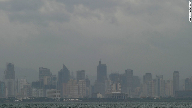The skyline of downtown Manila is shrouded in cloud and haze, brought on by Tropical storm Son-Tinh on Thursday.
