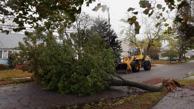 A tree felled by the storm blocks Kramer Drive in Lindenhurst, New York, on Monday.