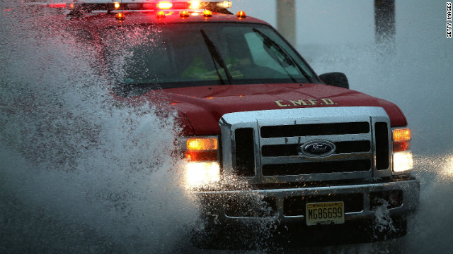 An emergency vehicle drives down Cape May, New Jersey's flooded Ocean Avenue on Monday.