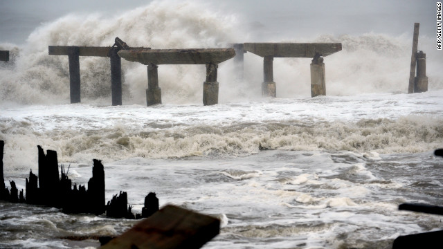 Waves crash against a previously damaged pier in Atlantic City, New Jersey, as Hurricane Sandy approaches landfall on Monday.