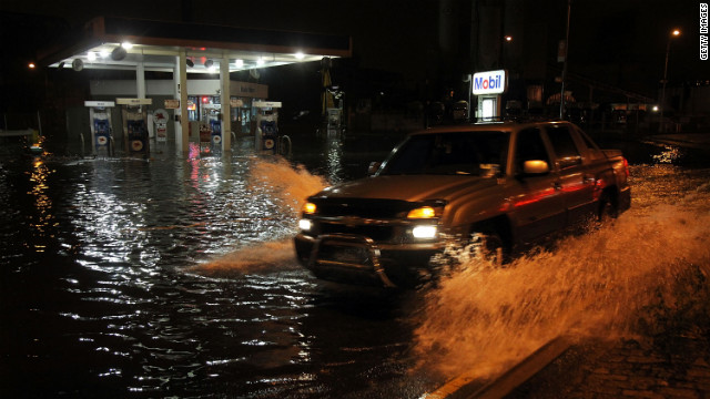 A truck drives by a flooded gas station in the Gowanus section of Brooklyn on Monday.