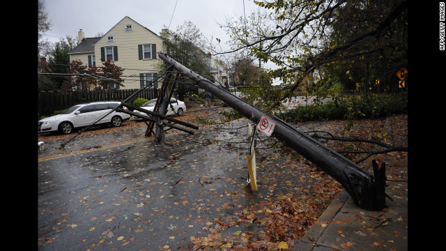 A power line knocked over by a falling tree blocks a street on Tuesday in Chevy Chase, Maryland.