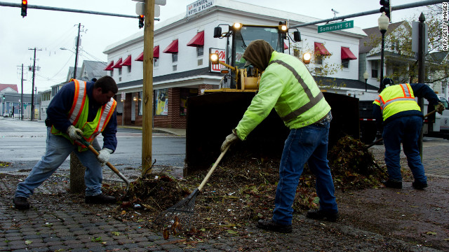 Workers shovel debris from the streets in Ocean City, Maryland, on Tuesday.