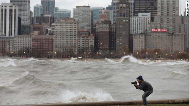A photographer shoots waves in Lake Michigan generated by the remnants of Sandy as they crash into the Chicago shoreline on Tuesday.