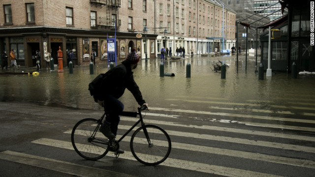 Superstorm Sandy left New York's South Street Seaport flooded and covered in debris on Tuesday.