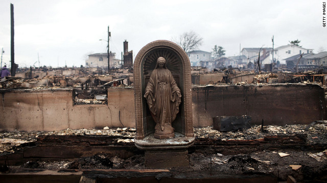 A Virgin Mary statue stands in the Breezy Point neighborhood of Queens, New York, on Tuesday after a fire fed by high winds destroyed at least 80 homes, officials said. 