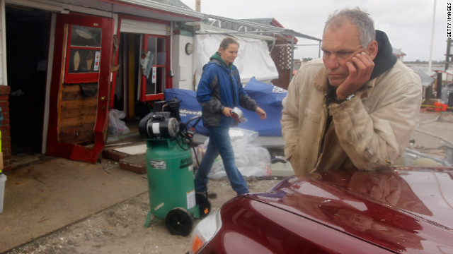 Ted Wondsel, owner of Ted's Fishing Station in Long Beach, assesses the damage to his business Tuesday.