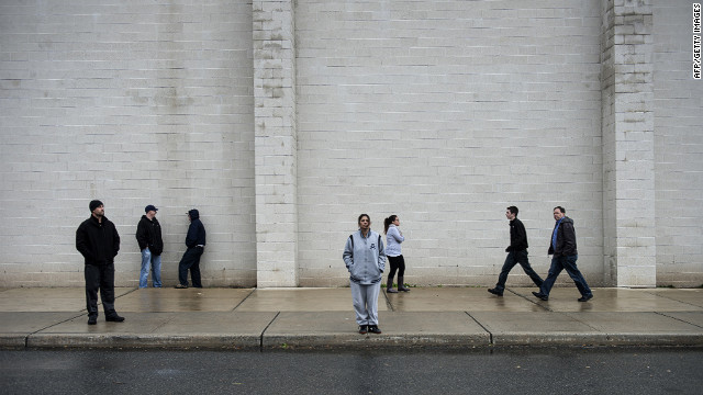 People wait outside a shelter at the Bergen County Technical Schools Teterboro Campus on Tuesday in Hasbrouck Heights, New Jersey. 