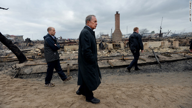 New York City Mayor Michael Bloomberg, center, views the damage Tuesday in the Breezy Point neighborhood of Queens, where a fire broke out during Superstorm Sandy and destroyed at least 80 homes. 