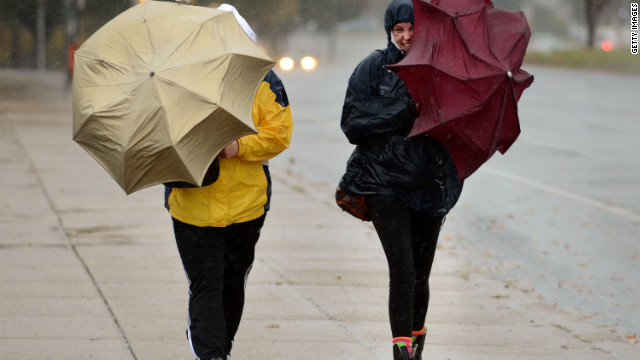 Two women battle wind and rain with umbrellas in hand in Philadelphia on Monday.