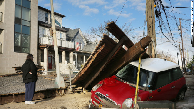 A woman examines damage to the Rockaway neighborhood in New York on Wednesday.