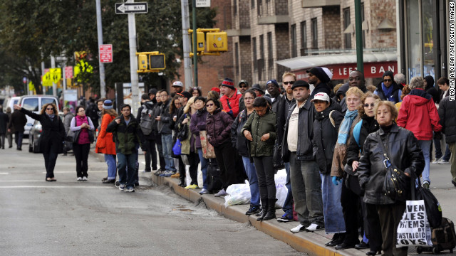 People wait for buses along New York's Sixth Avenue on Wednesday.