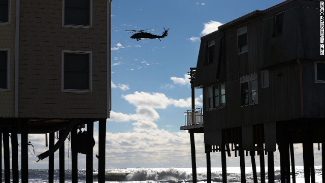  A helicopter flies past damaged homes in Long Beach Island, New Jersey, on Wednesday, October 31.