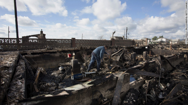 A resident looks through the remnants of his home in the Breezy Point neighborhood of Queens, New York.