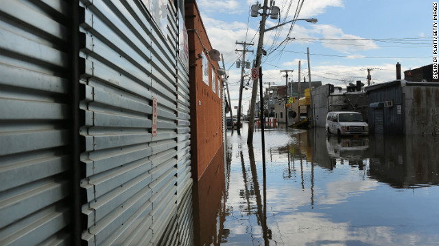 Water floods streets in the Rockaway section of Queens on Wednesday.