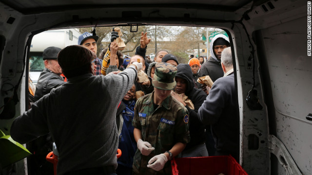 A Caring Foundation worker hands out food to residents of the heavily damaged Rockaway section of Queens on Wednesday.