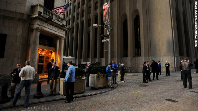 Traders stand outside of the New York Stock Exchange (NYSE) on Wednesday, October 31. U.S. equity markets resumed trading Wednesday for the first time this week after Hurricane Sandy.
