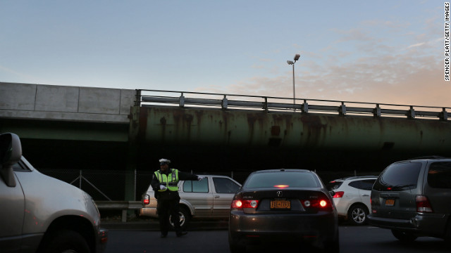 A police officer directs traffic entering the Brooklyn Queens Expressway into Manhattan. 