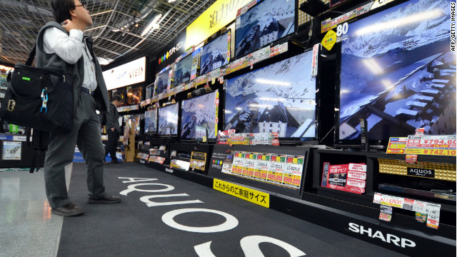 A customer checks LCD television sets made by Japanese electronics maker Sharp on November 1.