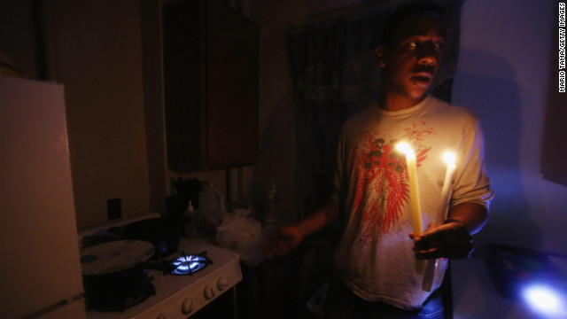 Geronimo Harrison's apartment in the East Village remains without power or water Thursday. He's using candles for light and a gas stove for heat.