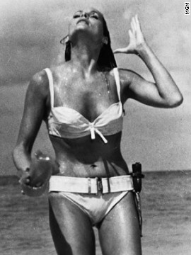 Ursula Andress played Honey Ryder opposite Sean Connery's James Bond in the 1962 film "Dr. No." Bond first sees Ryder as she emerges from the ocean wearing a white bikini. She asks him, "What are you doing here? Looking for shells?" He replies, "No. I'm just looking."